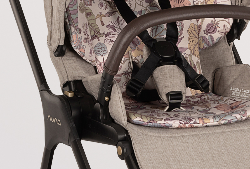 Close up of Nuna stroller showing coffee leatherette and brushed champagne details