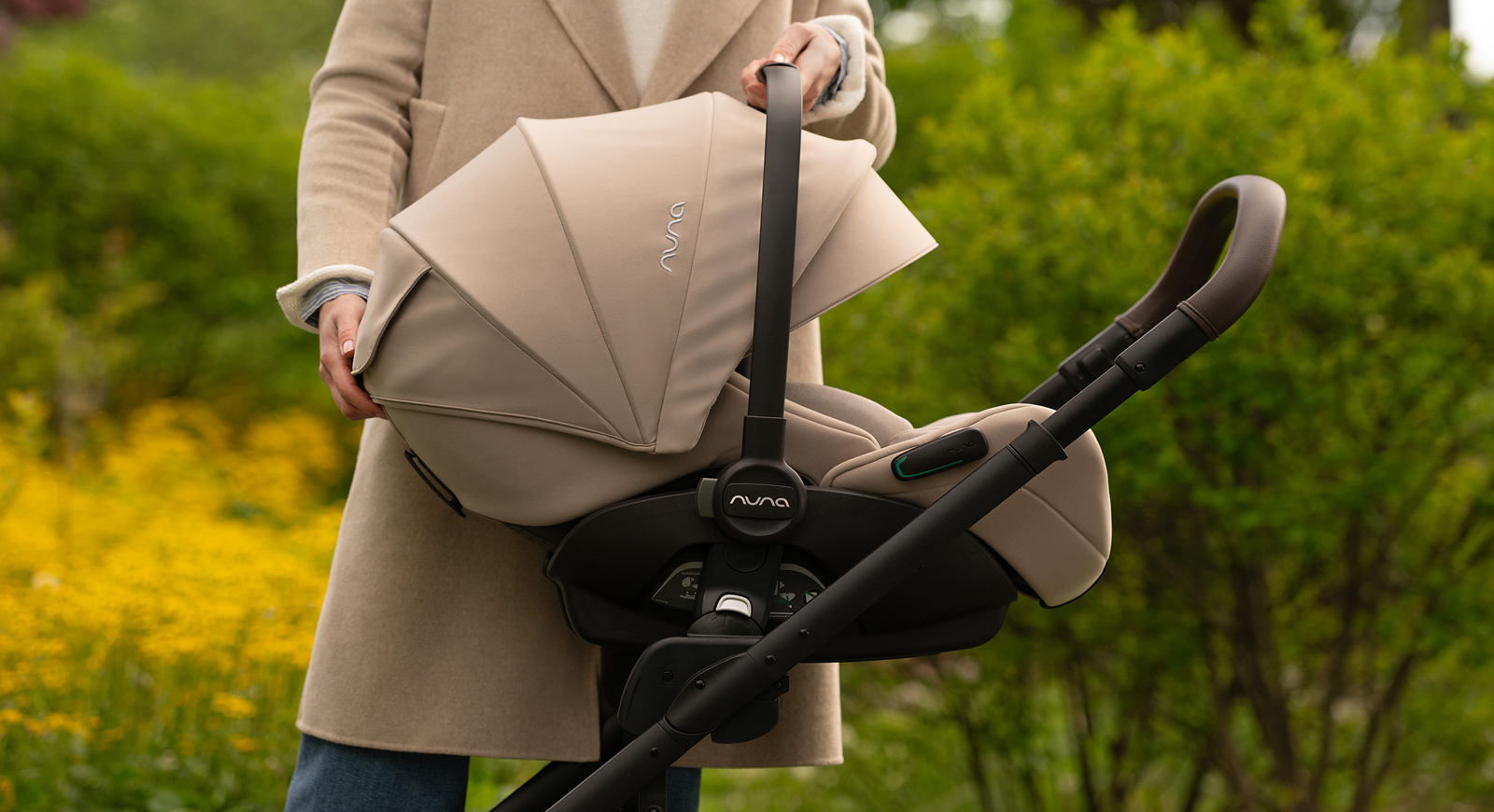 Close-up of the Nuna Arra Flex infant car seat clicking onto the Nuna Mixx Next stroller frame.
