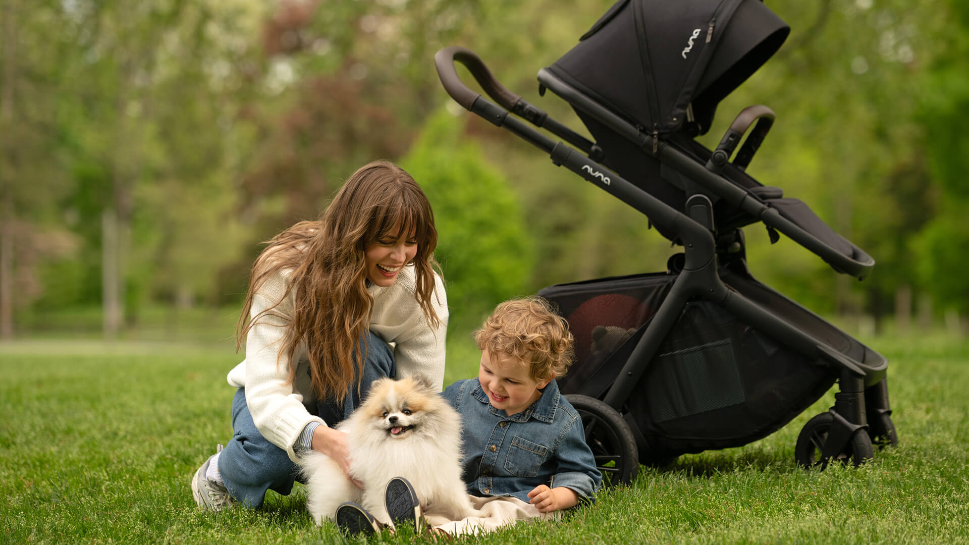 A young mother and child dressed for an outdoor walk with the Demi Icon pushchair.
