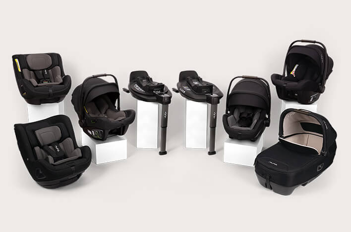 Collection of Next system car seats and bases on pedestals 