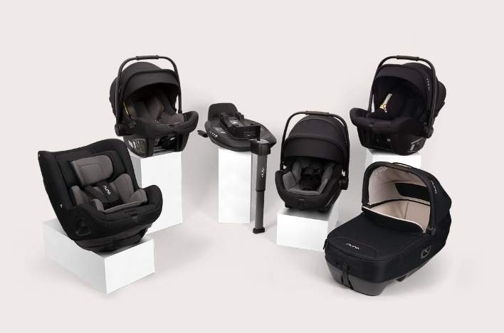 Collection of Next system car seats and bases on pedestals